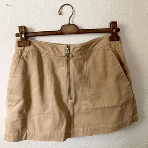 weekday beige mini skirt with white stitching and zipper fly